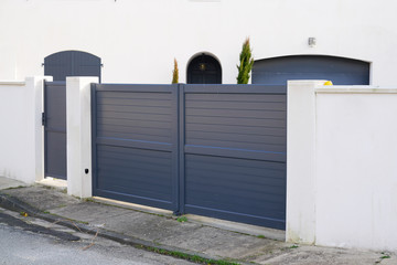 steel big grey metal gate fence on modern house street - obrazy, fototapety, plakaty