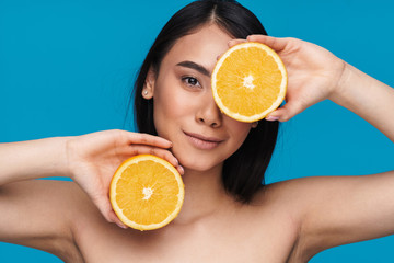 Woman posing with orange.