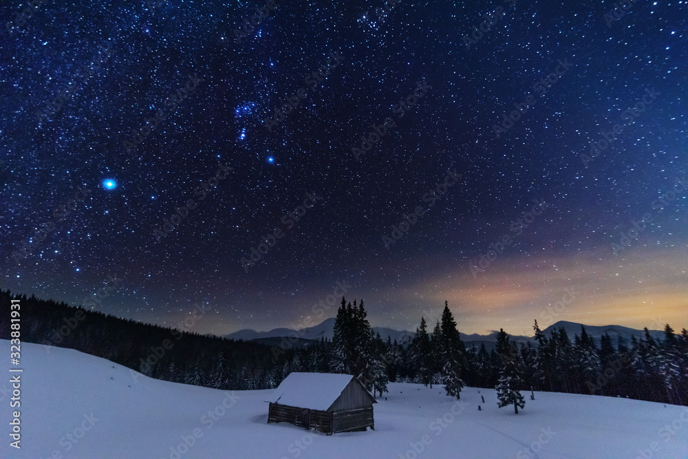 Wall mural a bright starry night in the mountains with the milky way in the sky, venus and millions of stars hi