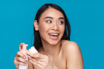 Optimistic young woman holding mousse cleansing foam.