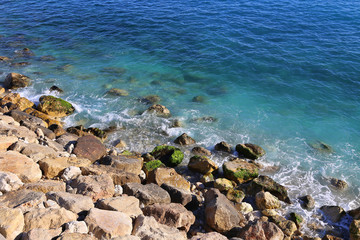 Fototapeta na wymiar Bright blue sea water and rocky coast