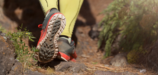 Trail running man on mountain path exercising