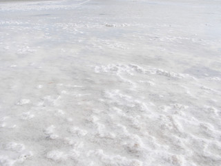 Obraz premium Natural white background. Granular crystalline salt desert texture. View of the bottom of a salt lake.