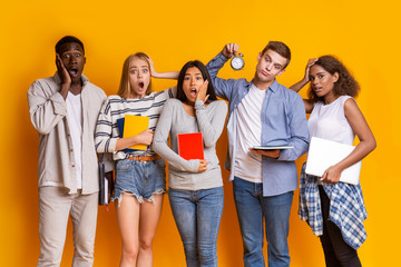 Fototapeta premium Stressed group of international students holding alarm