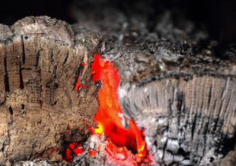 Fire background, red hot glowing charcoals inside stove