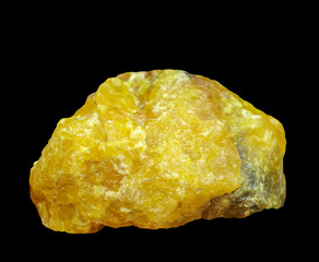 Yellow raw crystal ,isolated on a black background