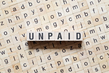 Unpaid Word Written In Wooden Cube