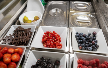 Berries and chocolate for ice cream topping at a sweets store in Bergamo, Italy
