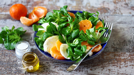 Healthy bright salad with mozzarella and mandarin. Citrus Salad. Diet concept.