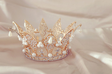 Vintage tiara over white delicate silk. Wedding concept. © tomertu