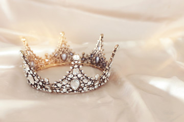 Vintage tiara over white delicate silk. Wedding concept.