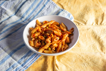 Fototapeta premium Penne pasta with tomatoes sauce and chicken. Italian traditional dish