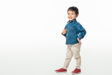 smiling and cute boy looking at camera on white background