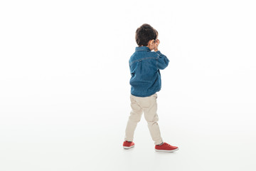 back view of boy in denim shirt on white background