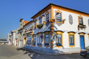 Old colorful typical facades next to the water canal in Aveiro village in Porto