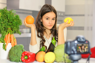Obraz premium Teenage blogger explains to her followers how to eat healthy. Concept of communication among young people on the importance of healthy eating habits, vitamins and calories.