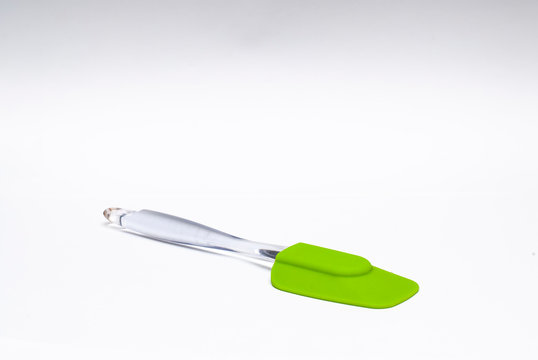 Green silicone spatula in a white background