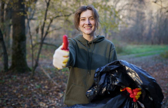 Portrait Of A Socially Active Volunteer Woman With A Garbage Bag In The Woods. The Concept Of The Right Way Of Life