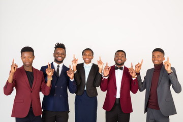 Fototapeta na wymiar team of young handsome african men and women in suits on a white background with hand gesture