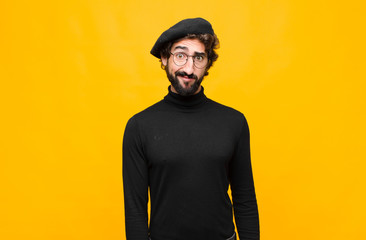 young french artist man feeling confused and doubtful, wondering or trying to choose or make a...