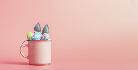 cute and cute easter background with circles from which the ears of the easter bunny peek out next to the easter eggs