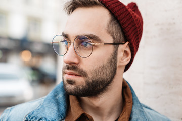 Close up of a handsome young stylish bearded man
