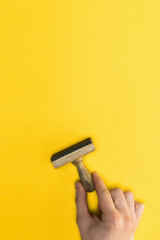 top view of man holding stamp isolated on yellow, quality concept