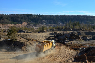 Dump truck transports sand and other minerals in the mining quarry.