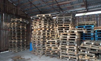 Warehouse with wooden walls. Storage of wooden pallets.