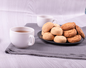 Two cups of black tea with sweeties