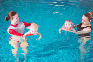 young mother teaches her child to swim