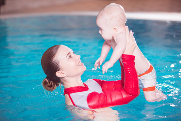 young mother teaches her child to swim