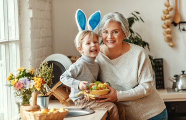 Happy easter! family grandmother and child with ears hare getting ready for holiday.