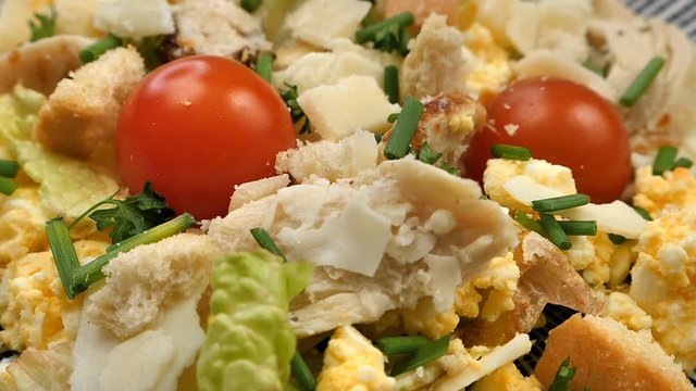 top view of a caesar salad on a white wooden background.