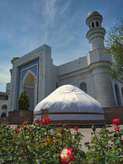 A traditional yurt in front of mosque in Almaty, Kazakhstan.