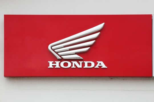 Peronnas, France - April 7, 2019: Honda motorcycle logo on a wall. Honda is a Japanese public multinational corporation primarily known as a manufacturer of automobiles and motorcycles 
