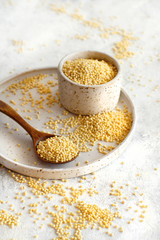 Raw dry hulled millet in a ceramic bowl