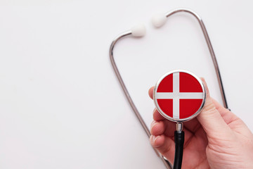 Denmark healthcare concept. Doctor holding a medical stethoscope.