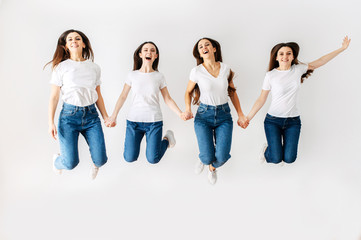 A group of girls in the studio are jumping