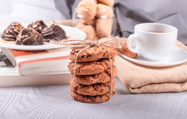 chocolate, sweet snacks and cup of tea on the table