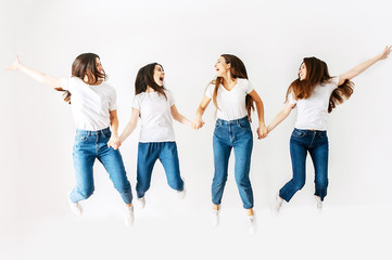 A group of girls in the studio are jumping