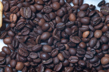 close-up fragrant roasted coffee beans, brown saturated color