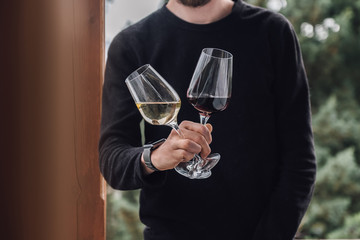 man holds two glasses of wine