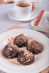 book,chocolate and cup of tea on the table