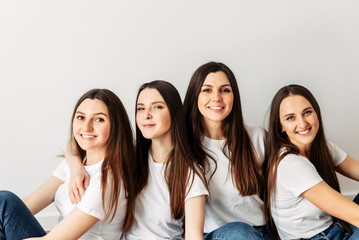 A group of young girls in identical white t-shirts