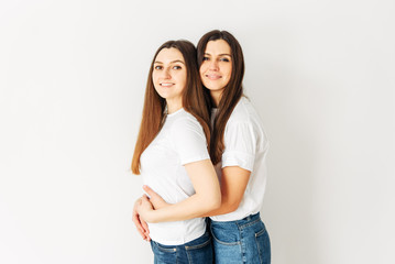 Fototapeta premium Two attractive young girls in the studio