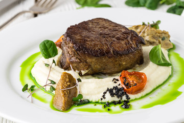 Delicious beef steak on wooden table, close-up