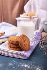 Cup of milk with cinnamon biscuits and flour