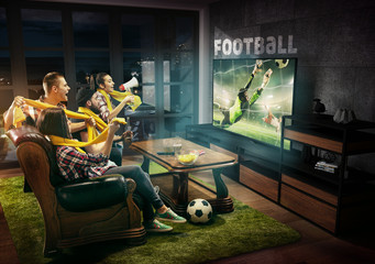 Group of friends watching TV, football match, championship, sport games. Emotional men and women...