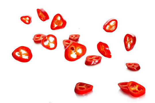 Chili pepper and its slices close-up falling